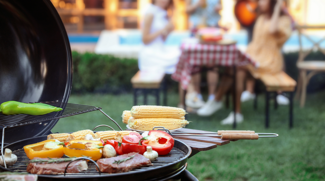 A braai cooking away while people wait at a table - braai gifts - Picnic