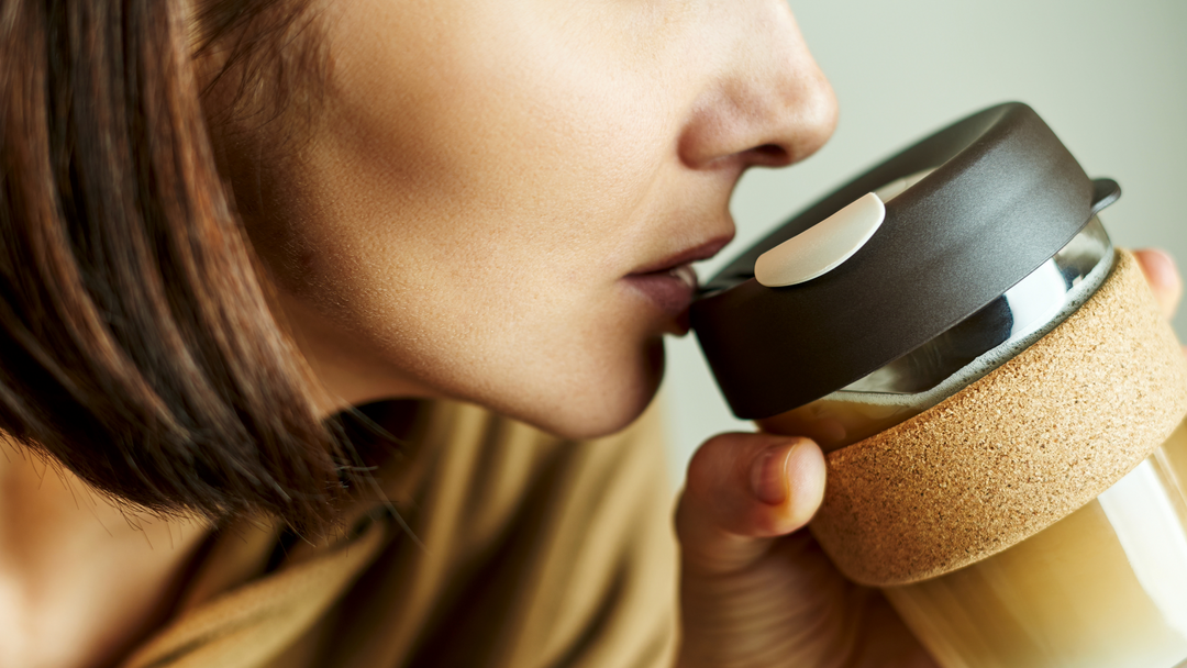 A lady sipping from a glass travel mug - travel mug - corporate gifts pretoria
