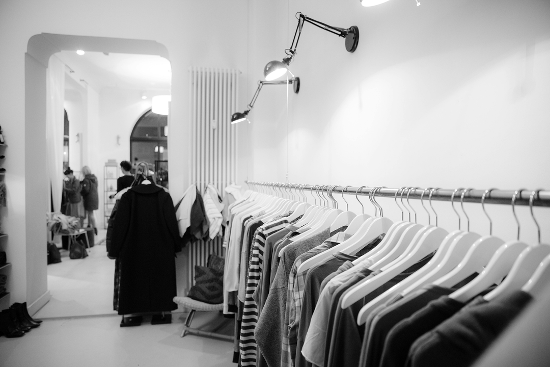 Apparel hanging in a room // clothing printing, cheap t shirt printing