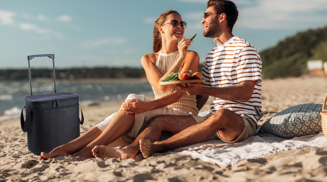 Couple on beach with their Day Trip 32 Can Trolley Cooler - Trolley Cooler bag - cooler bag