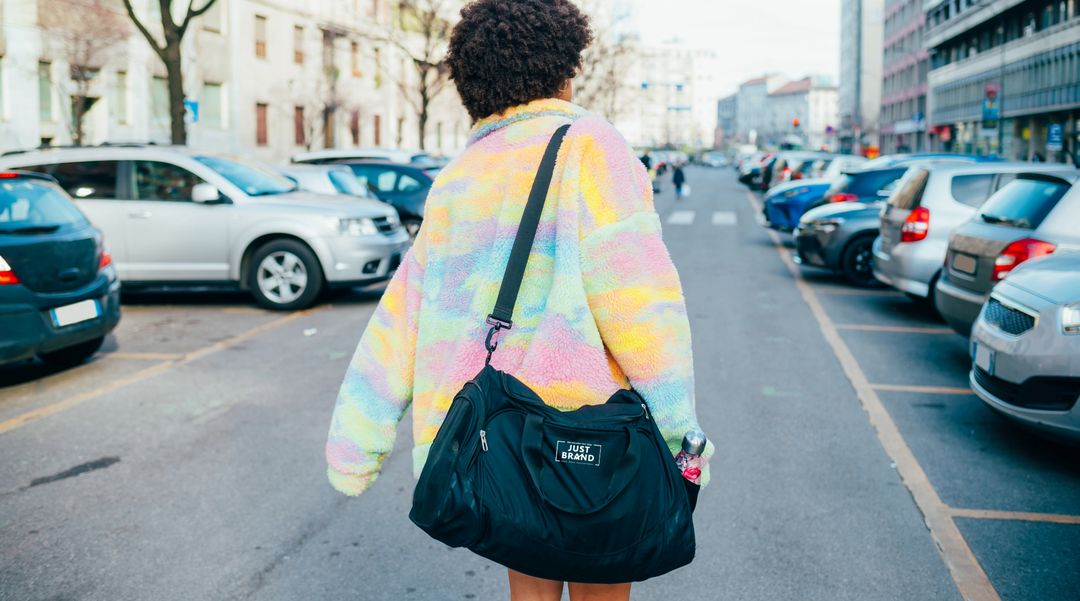 Lady carrying a small duffle bag - duffle bag - Bag