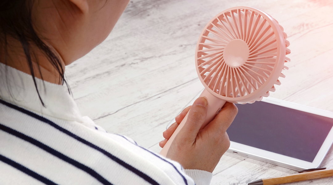 Lady holding the USB rechargeable mini fan - mobile fan - portable fan