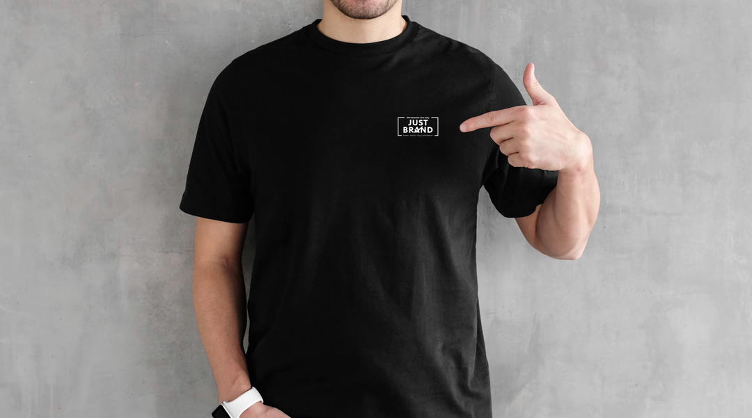 Man pointing at Just Brand logo on shirt - branded t shirts - t shirt