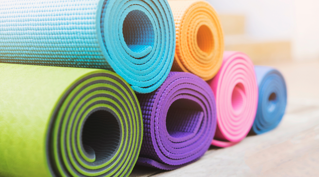 Pile of different exercise mats - exercise mat - best sports promotional giveaways