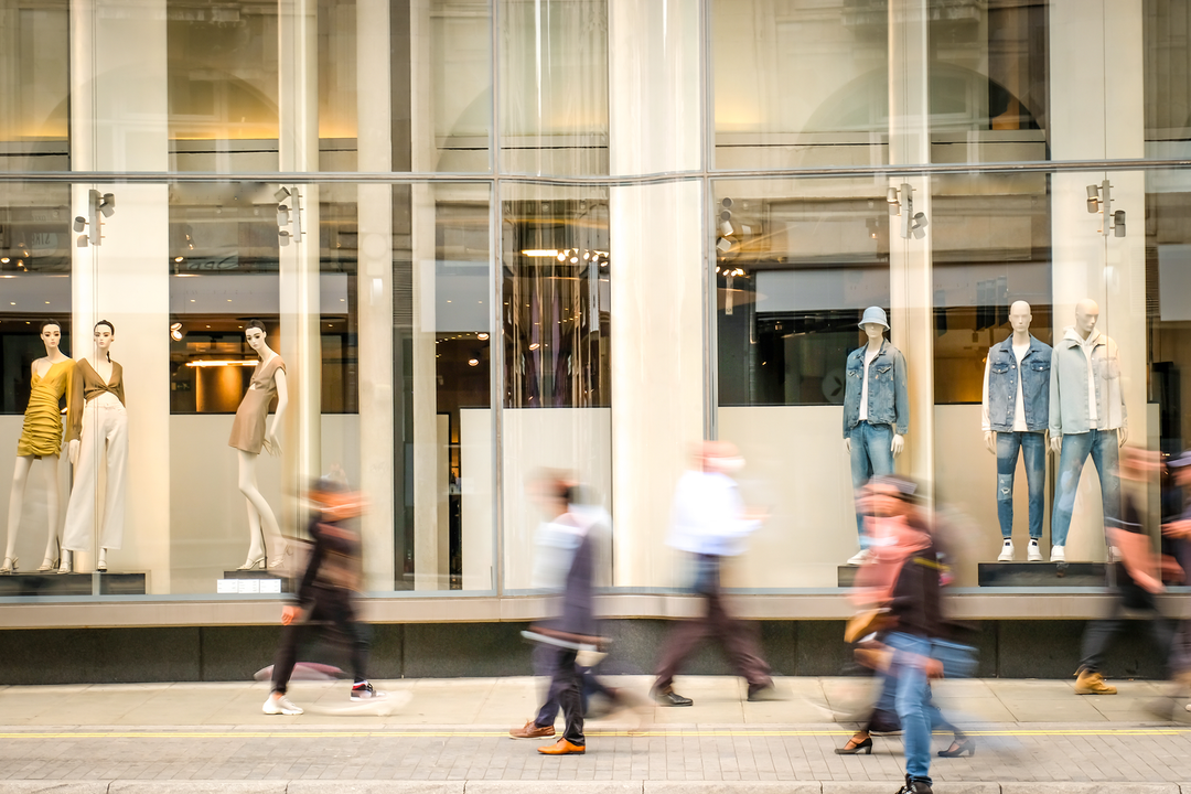 Shoppers walking past a window display // retail industry in south africa, Promotional items, how to increase sales in retail