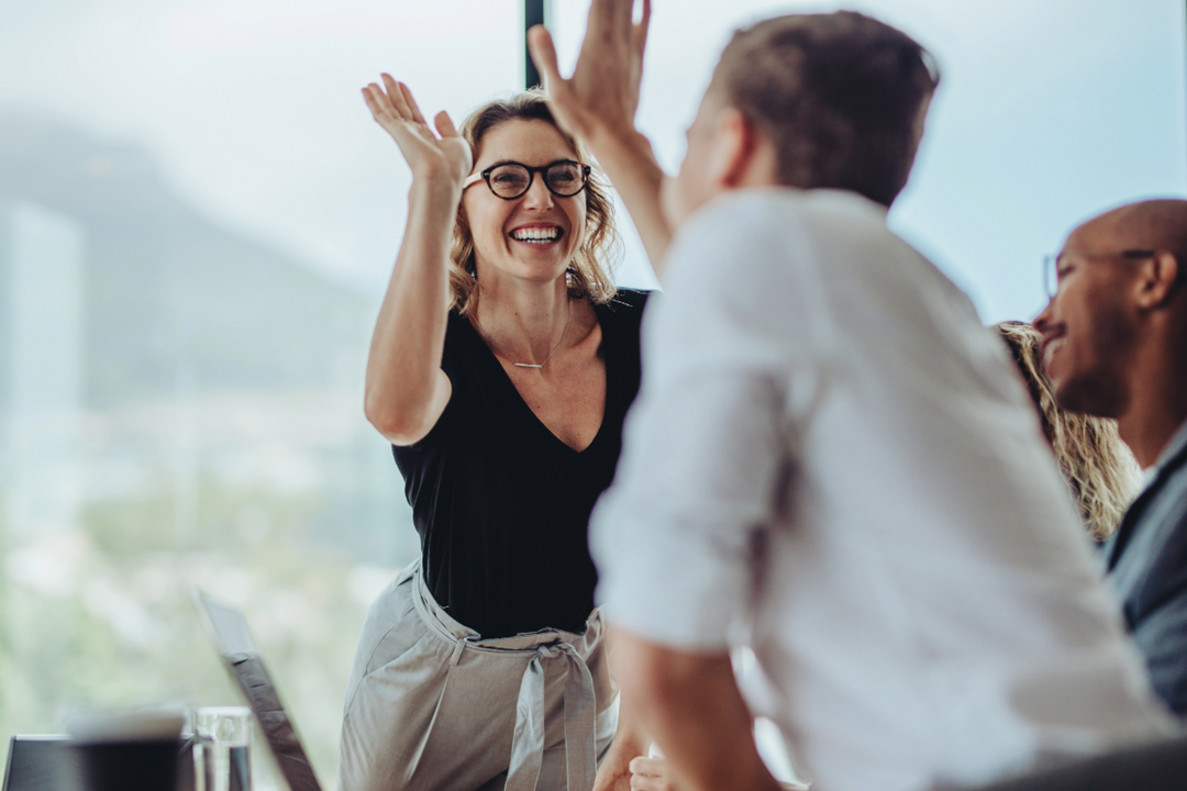 Woman and man giving each other a high five.