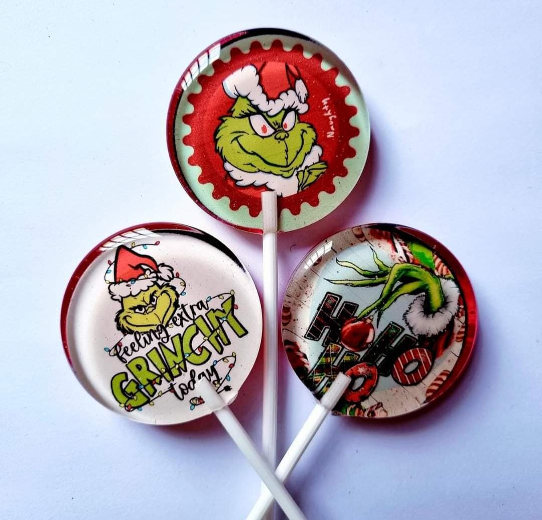 Three example Grinch lollipop designs; sold individually